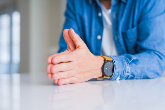 Close up of man hands with palms together over white table