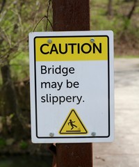 A close view of the yellow and white caution sign.