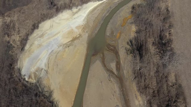 Above polluted river with mine drainage 4K aerial video