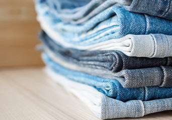 denim blue jeans stack on wood table background