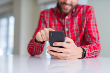 Close up of man hands using smartphone and smiling