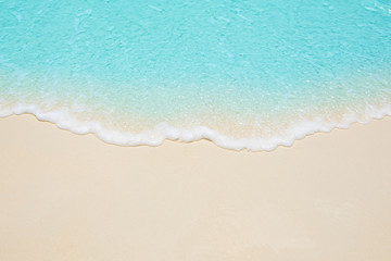 Obraz na płótnie Canvas Soft waves of blue sea on the Maldives beach for the background.