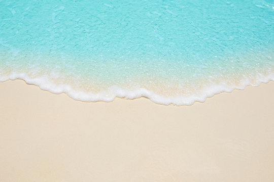 Soft waves of blue sea on the Maldives beach for the background.