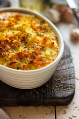 Casserole from broccoli and chicken fillet. The casserole is made from chicken breast, broccoli cabbage, onion, sauce, grated cheese. Chicken fillet is rich in protein. Foam for sports nutrition.
