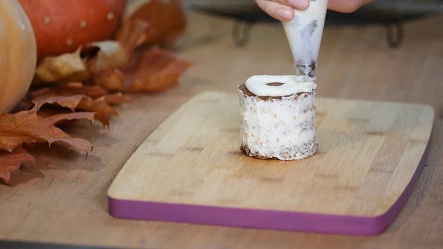 Woman in kitchen making pumpkin small cake
