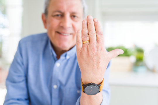 Close up of man hand showing alliance ring