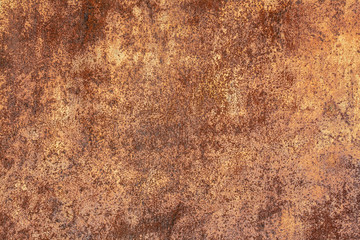 Rusty yellow-red textured metal surface. The texture of the metal sheet is prone to oxidation and corrosion. Textured background in grunge style