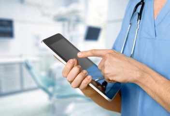 Young doctor with stethoscope, partial view