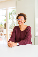 Beautiful young african woman with afro hair wearing glasses