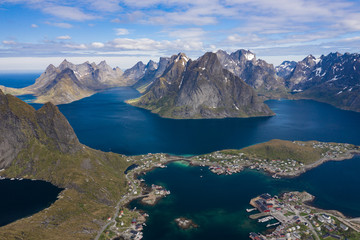 Fototapeta na wymiar Aerial view of Reine, Lofoten islands, Norway. The fishing village of Reine. Spring time in Nordland. Blue sky. View from above.