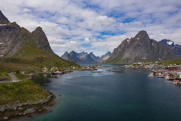 Naklejka na ściany i meble Aerial view of Reine, Lofoten islands, Norway. The fishing village of Reine. Spring time in Nordland. Blue sky. View from above.