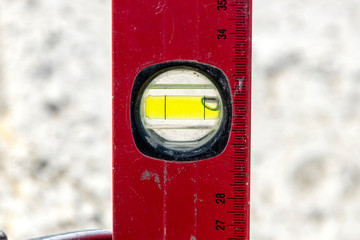 A close up image of a leveling tool being used