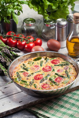 Frittata made of eggs, asparagus and tomatoes