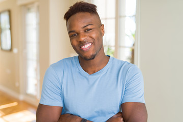 Fototapeta premium Handsome african american man wearing casual t-shirt happy face smiling with crossed arms looking at the camera. Positive person.