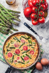 Frittata made of eggs, asparagus and tomatoes
