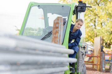 Obraz na płótnie Canvas female construction apprentice learning to drive heavy equipment