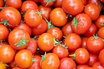 Bunch of whole cherry tomatoes forming background