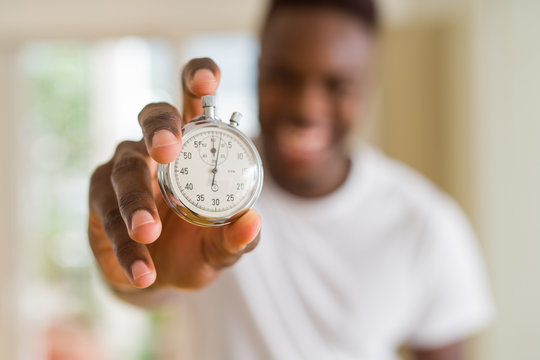 Young African Man Holding Silver Retro Stopwatch Counting Time