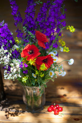 Bouquet of wilfd flowers, poppies, daisies, violets