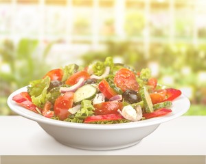 Close-up photo of fresh salad with vegetables in white plate