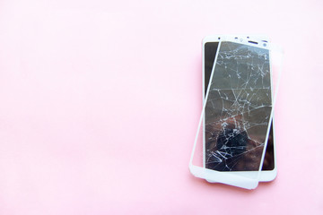 Mobile smartphone with broken glasstouch screen isolated on pink backgroung. copyspace fo text....