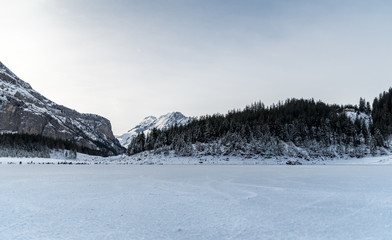 Fototapeta na wymiar ice skating on frozen Oeschinensee lake in Berner Oberland