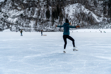 girl skating on the ice of a frozen lake