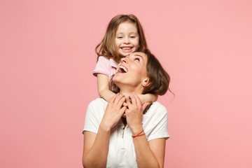 Woman in light clothes have fun with cute child baby girl. Mother, little kid daughter isolated on pastel pink wall background, studio portrait. Mother's Day, love family, parenthood childhood concept - obrazy, fototapety, plakaty