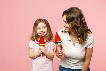 Woman in light clothes have fun with cute child baby girl. Mother, little kid daughter isolated on pastel pink wall background, studio portrait. Mother's Day, love family, parenthood childhood concept