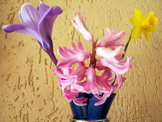 Mix of colors Mix of flowers with colors variation from purple pink soft to bold yellow all in a blue glasses container