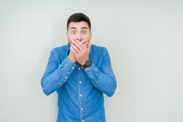 Young handsome man over isolated background shocked covering mouth with hands for mistake. Secret concept.