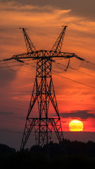 Power line pole on the background of sunset and beautiful sky