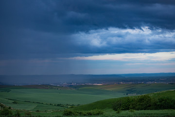 Fototapeta na wymiar Heavy rain over the meadows at evening.