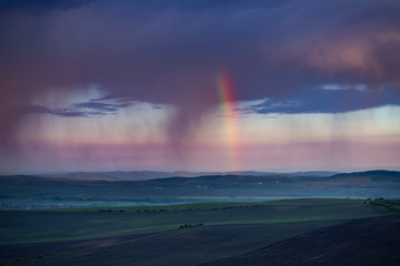 Naklejka na ściany i meble Rainbow and storm over the meadows.