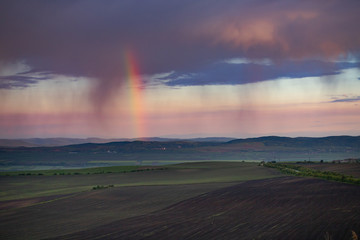 Rainbow and storm over the meadows.