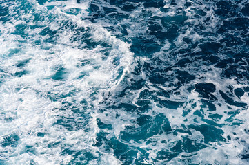 Blue sea water with foam