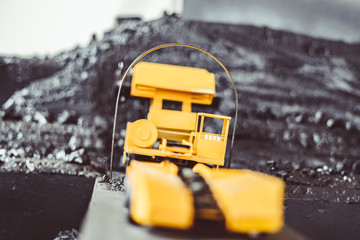 toy tractor in the scenery of coal mining