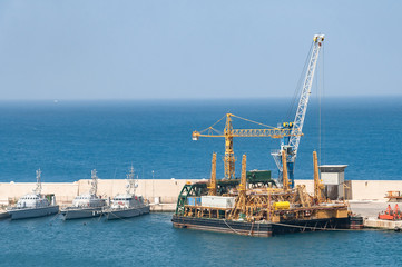 Fototapeta na wymiar Big cargo port with cranes moving containers. Cargo dock in Italy.