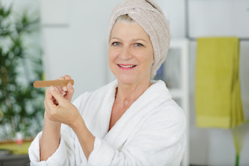 portrait of mature woman filing her nails