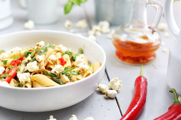Penne  pasta with asparagus, smoked tofu, chilli peppers and mini corn onions in nut sauce