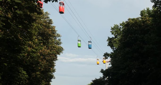Cableway telpher on a background of blue sky in sunset time different colors diagonal movement