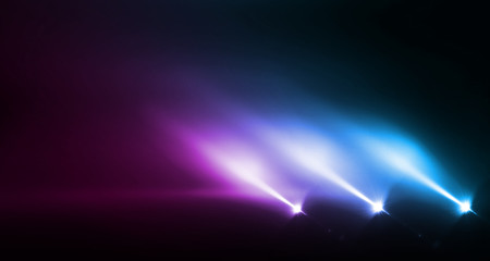 Background of empty stage show. Neon blue and purple light and laser show. Laser futuristic shapes on a dark background. Abstract dark background with neon glow