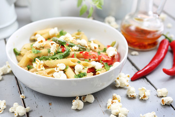 Penne  pasta with asparagus, smoked tofu, chilli peppers and mini corn onions in nut sauce