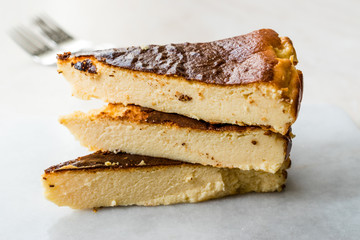 San Sebastian Cheesecake Slice on Marble Surface / Creamy Plain New York Style.