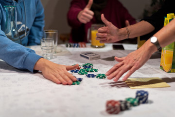 Friends play poker, the winner takes the chips of the money bet or pot.