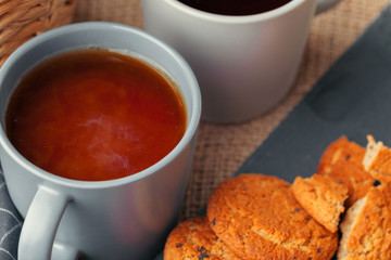 Tea with cookies on sackcloth background close up
