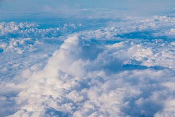 View from the porthole of airplane of a beautiful cloudscape of stratocumulus clouds