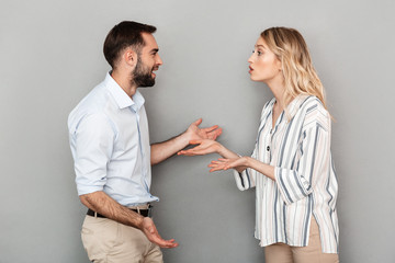 Photo of tense couple in casual clothes discussing problems and arguing
