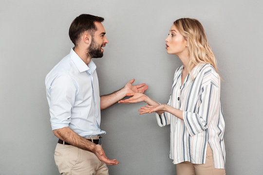 Photo Of Tense Couple In Casual Clothes Discussing Problems And Arguing