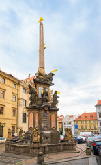Prague, Czech Republic-February 01, 2019. Column of the Holy Trinity in front of the Church of St Nicholas and is 20m high and decorated with a statue of the Holy Trinity and the Czech patron saints. 